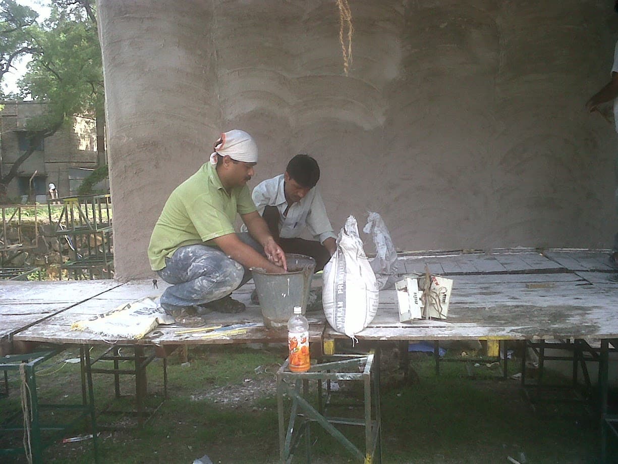 Friends working together to build Ashwini and Shaily's wedding stage