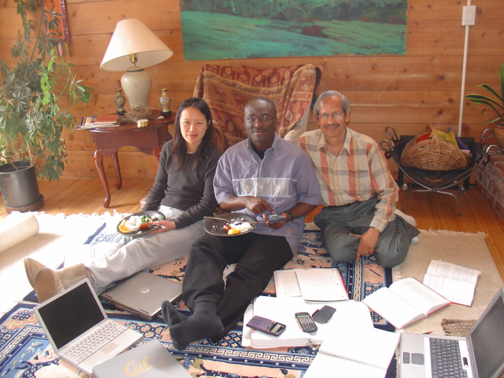 Dr. S.P. Kalantri, Christine Ho, and Joseph Ezoua studying together at Christine's home in Marin County, San Francisco Bay Area, April 2005. Three laptops, two calculators, and open notebooks on the floor. Christine tutored Dr. Kalantri in medical statistics during the MPH year at UC Berkeley.