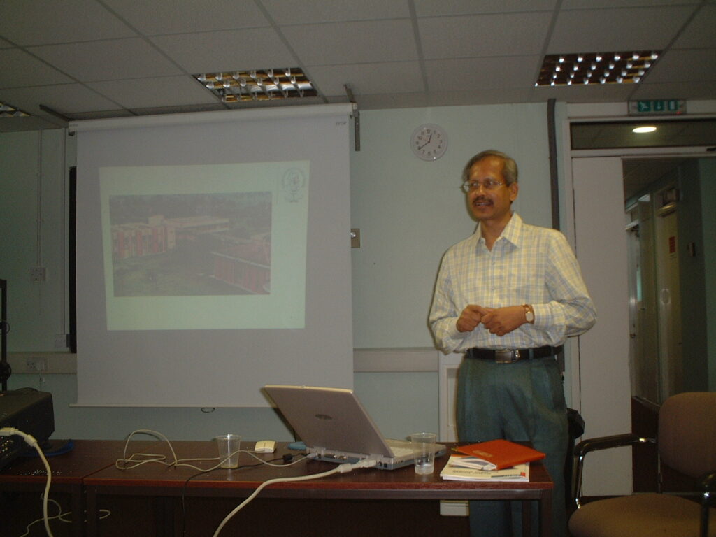 Dr. S.P. Kalantri presenting MGIMS Sevagram to an audience in London, 2003, which included Dr. Maurice King, author of Primary Child Care. MGIMS alumni in the UK arranged and supported the visit.
