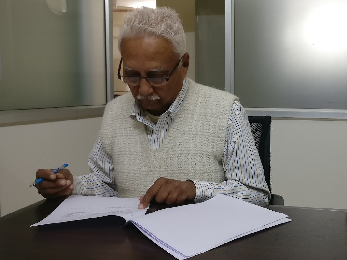 Dr. Samit Kumar Ghosh, Professor of Anatomy at MGIMS Sevagram, seated at his desk reviewing documents