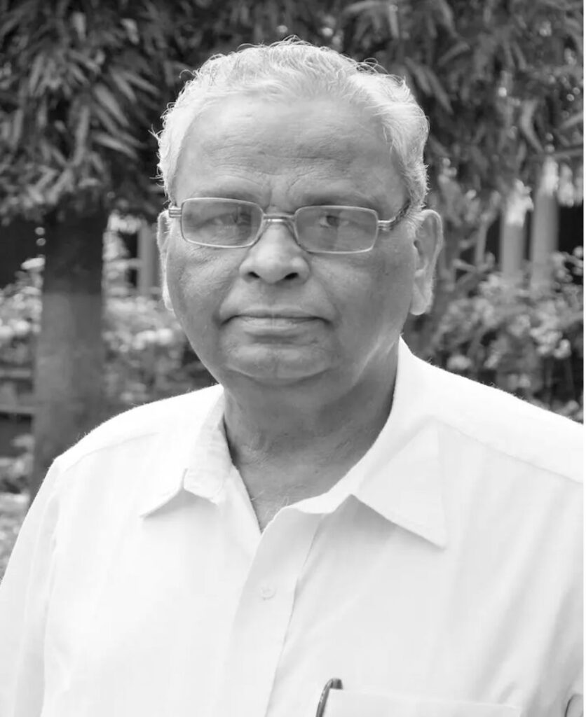 Black and white portrait of Dr. B.C. Harinath, former Dean and Head of Biochemistry at MGIMS, Sevagram.