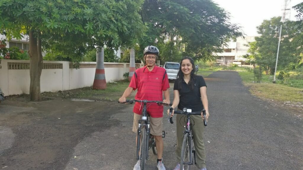 SP Kalantri and daughter Amrita Kalantri with their bicycles on Gandhi Ashram Road, Sevagram, 2024.