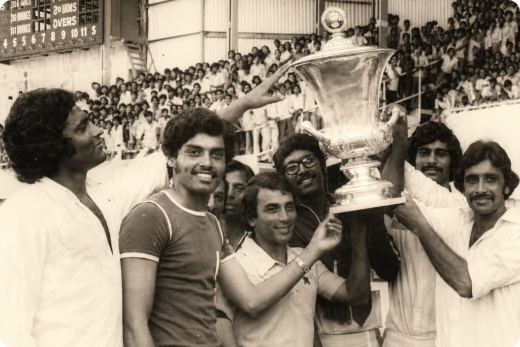 Young Dilip Vengsarkar celebrates with the Irani Trophy after the 1975–76 Irani Trophy match in Nagpur. I watched this memorable match from the East Stand as a medical student.